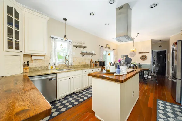 a kitchen with stainless steel appliances kitchen island granite countertop a sink and cabinets