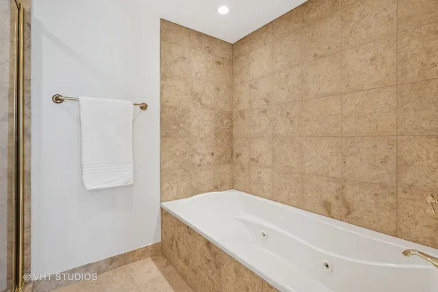 a bathroom with a bathtub and shower
