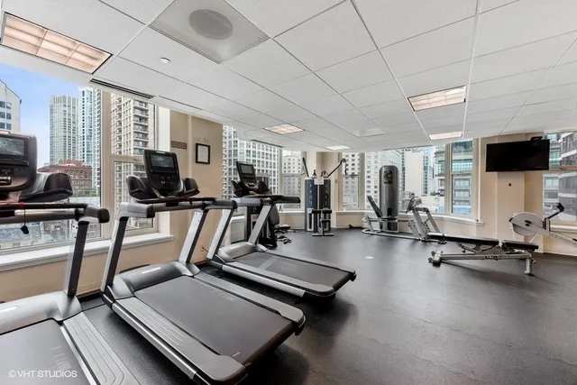 a room with gym equipment and a flat screen tv