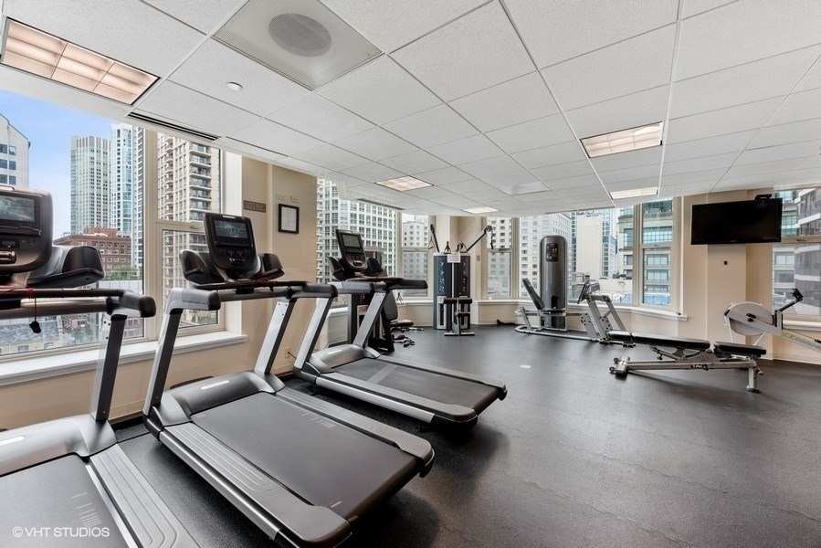 25 East Superior Street, Unit 2405 Chicago, IL 60611 - Photo 21 of 26 a room with gym equipment and a flat screen tv