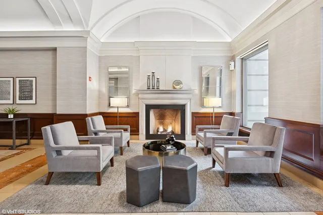 a living room with furniture a fireplace and a large window