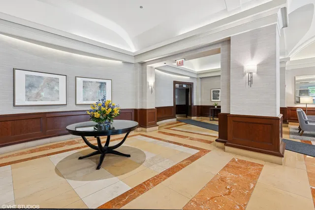 a living room filled with furniture and a painting on the wall