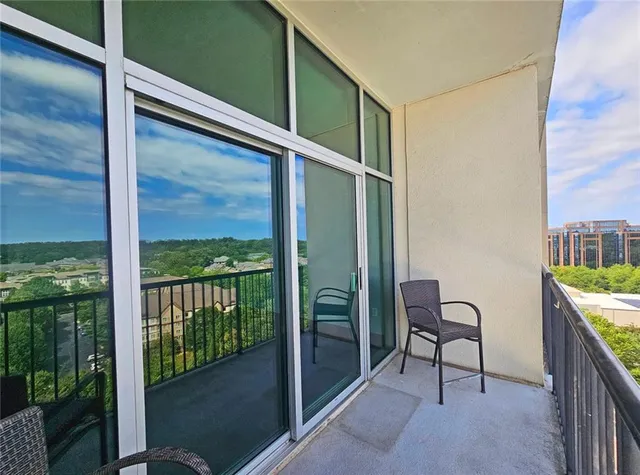 a balcony with chairs and an outdoor view