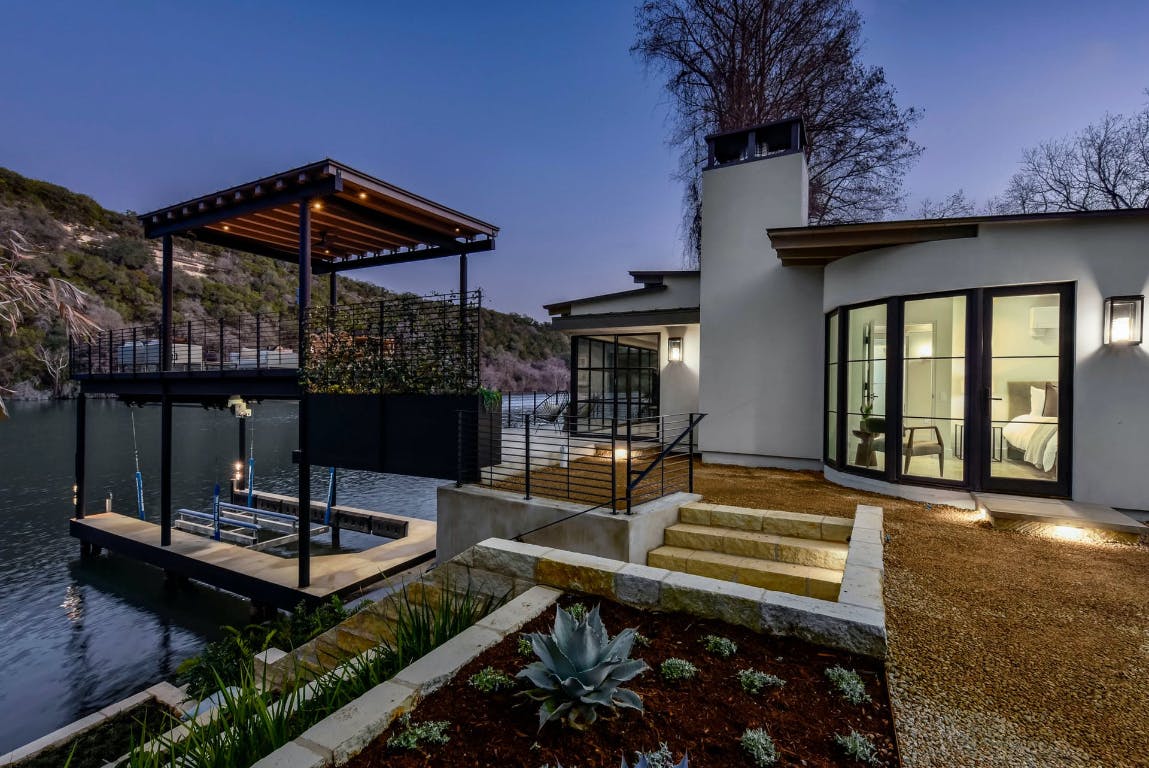 a view of a patio with a table chairs and a barbeque