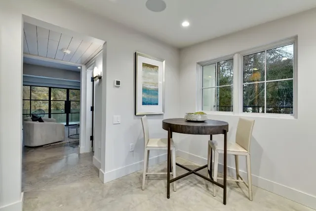 a dining room with furniture and window