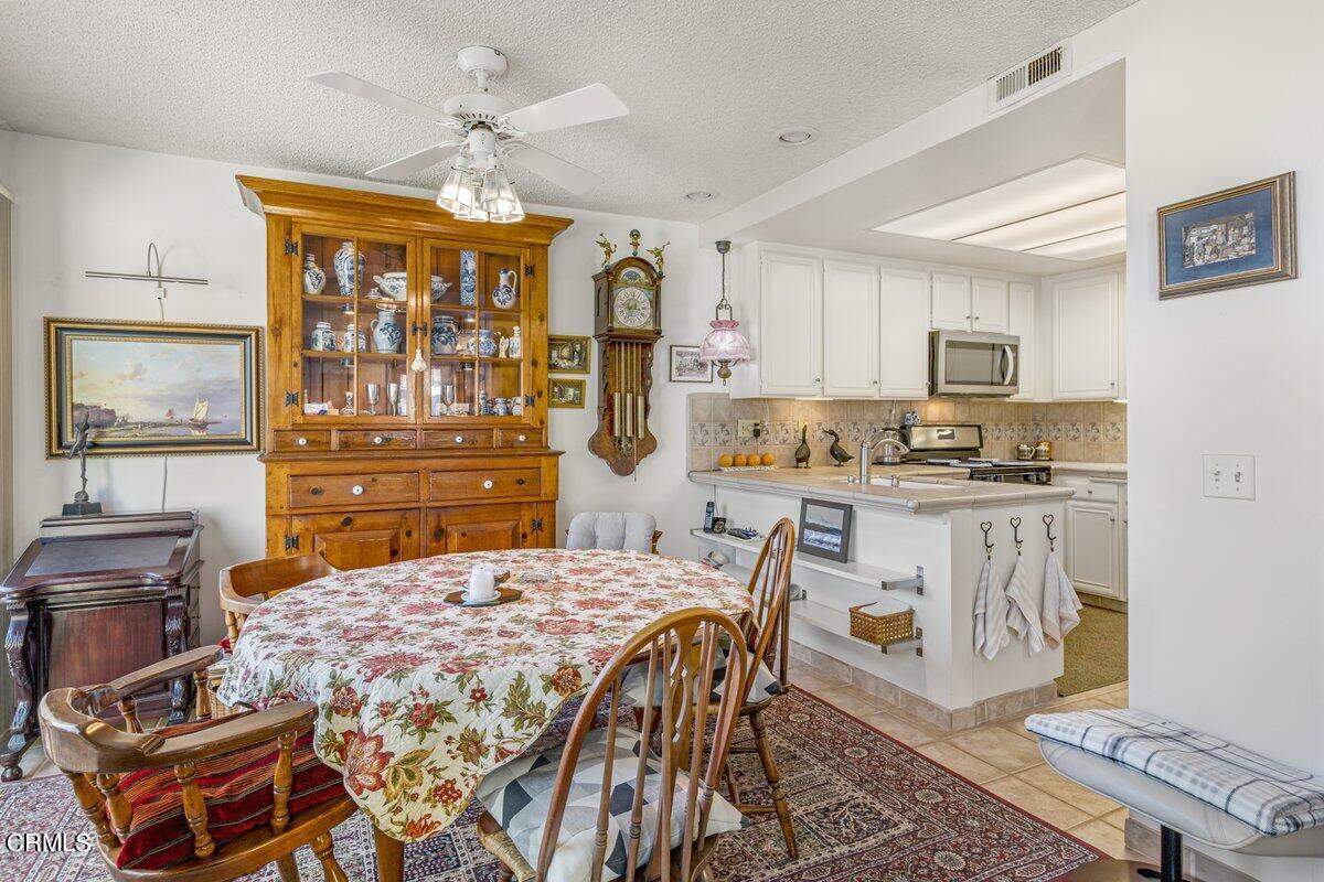 3330 Sunset Lane Oxnard, CA 93035 - Photo 11 of 29 a kitchen with a table chairs stove and cabinets