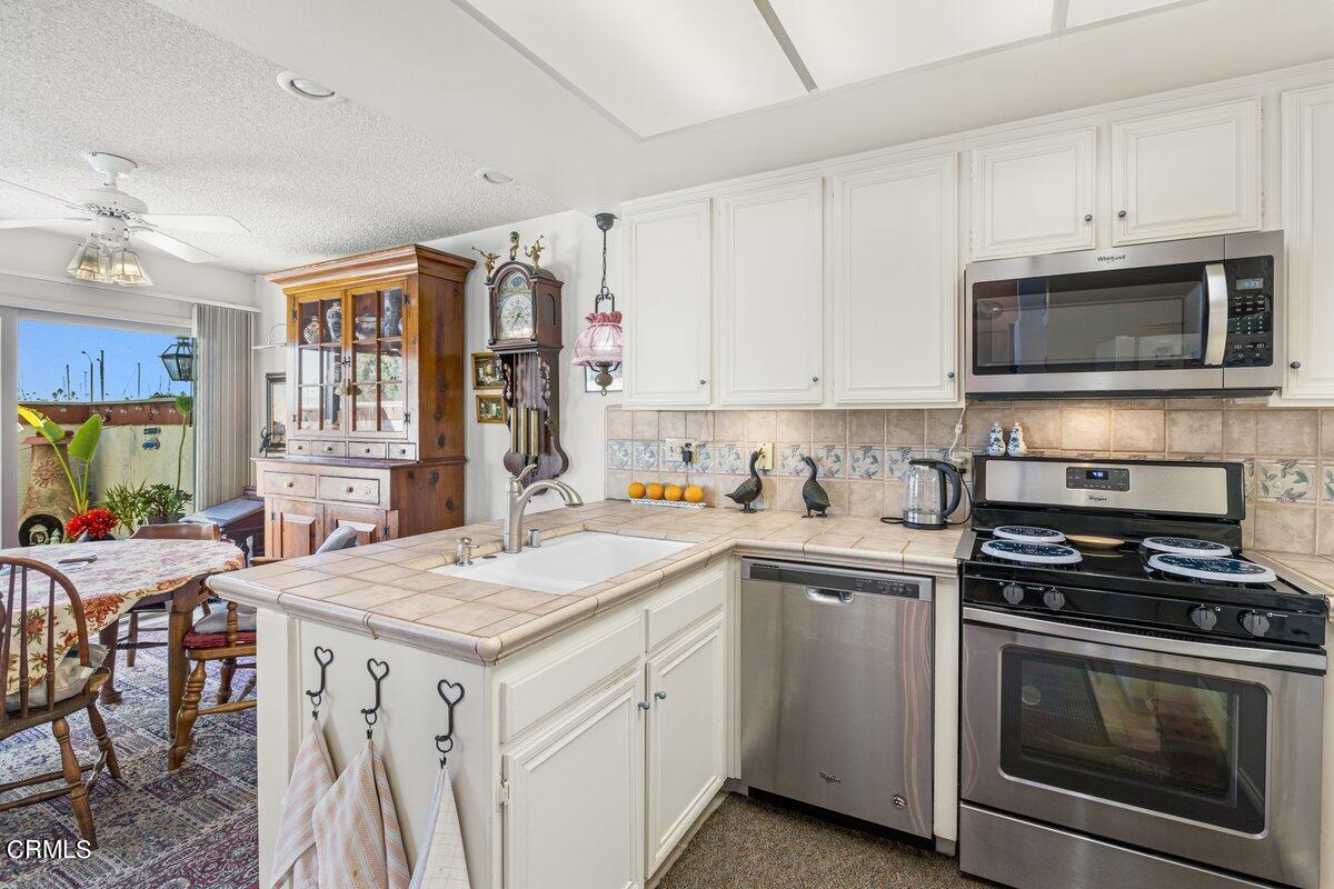 3330 Sunset Lane Oxnard, CA 93035 - Photo 14 of 29 a kitchen with a stove sink and microwave