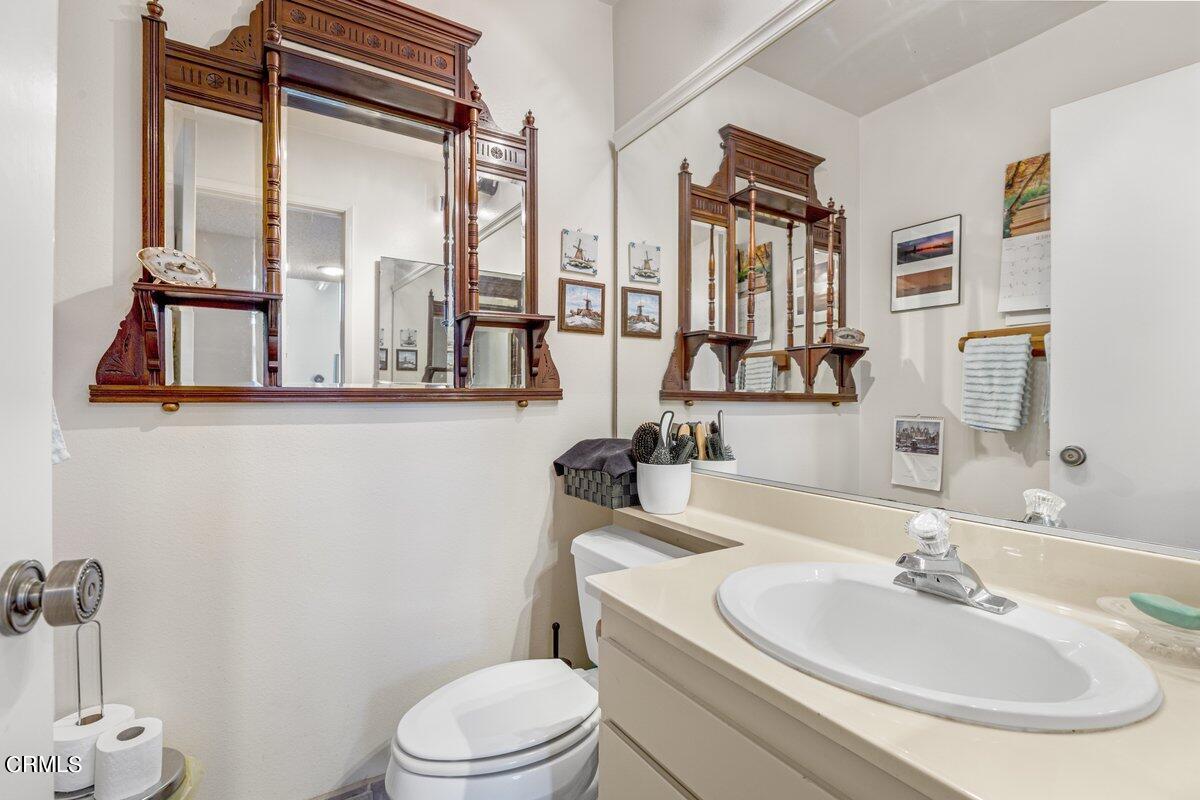 3330 Sunset Lane Oxnard, CA 93035 - Photo 15 of 29 a bathroom with a toilet a sink and a mirror