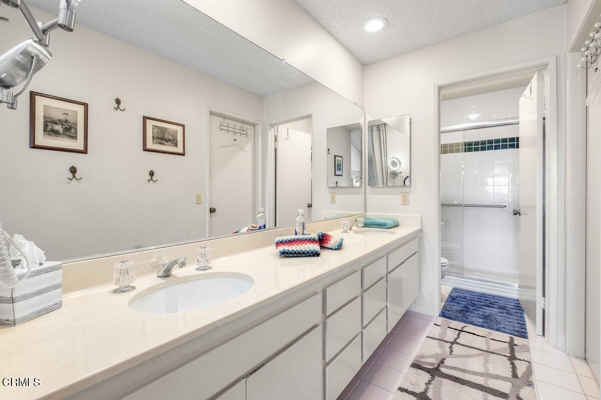 3330 Sunset Lane Oxnard, CA 93035 - Photo 18 of 29 a bathroom with double vanity sinks a toilet a mirror and shower