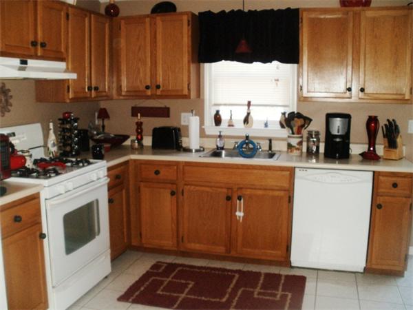 73 Musquash Road Hudson, NH 03051 - Photo 5 of 14 a kitchen with stainless steel appliances granite countertop a sink stove and cabinets