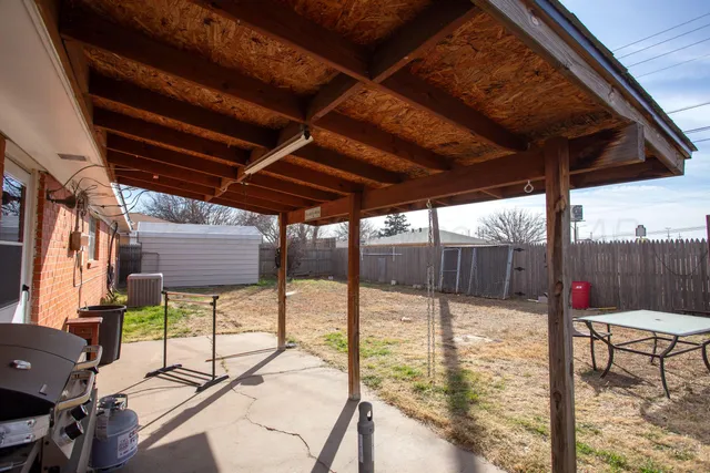 a roof deck with table and chairs