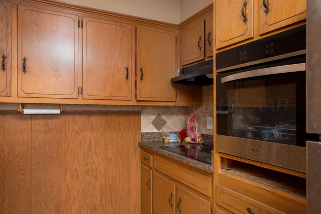 a kitchen with a refrigerator and cabinets