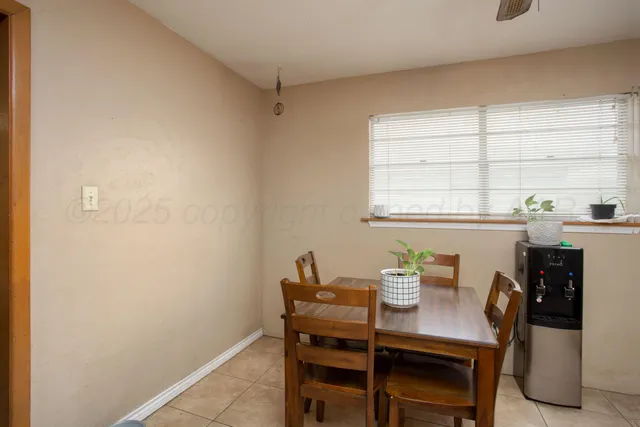 a view of a dining room that has a table and chairs in it