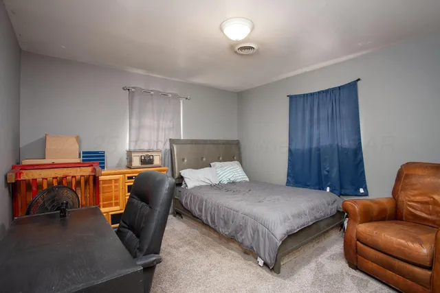 a bedroom with a bed and a couch