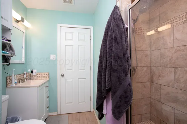 a bathroom with a sink toilet and shower