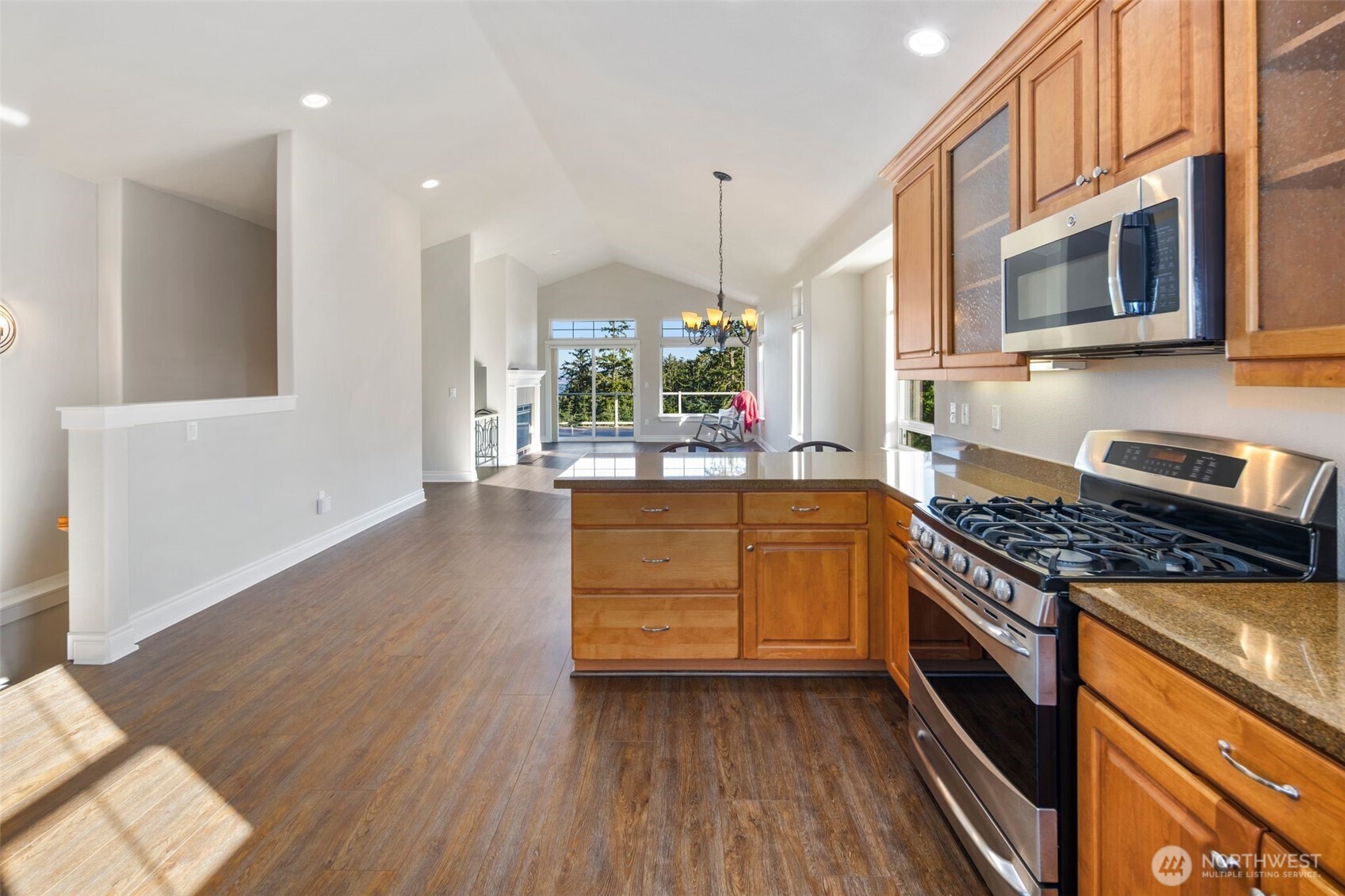 3224 Overlook Loop Ilwaco, WA 98624 - Photo 11 of 40 a kitchen with stainless steel appliances granite countertop a stove and a wooden floors