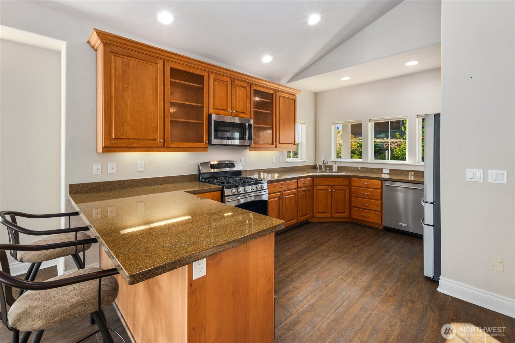 3224 Overlook Loop Ilwaco, WA 98624 - Photo 13 of 40 a kitchen with stainless steel appliances granite countertop a sink stove and refrigerator
