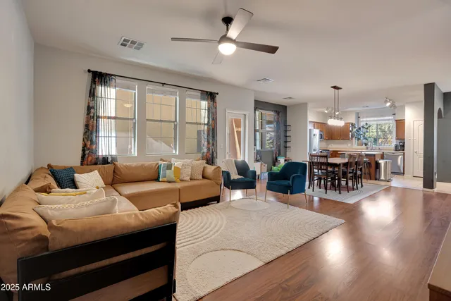 a living room with furniture and wooden floor
