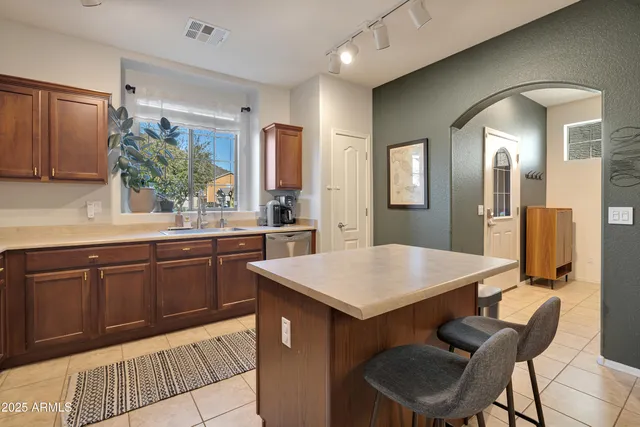 a kitchen with a sink cabinets and wooden floor