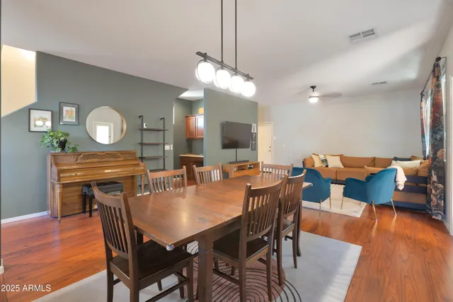a view of a dining room with furniture and wooden floor