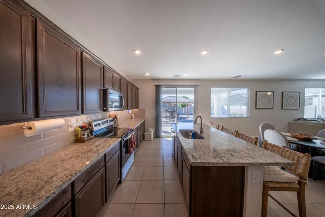 a kitchen with granite countertop lots of counter top space and stainless steel appliances