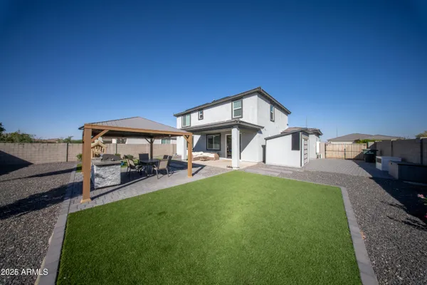 a view of a house with backyard porch and sitting area