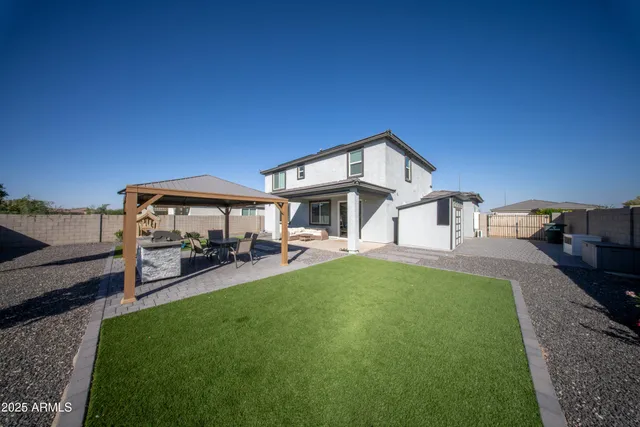 a view of a house with backyard porch and sitting area