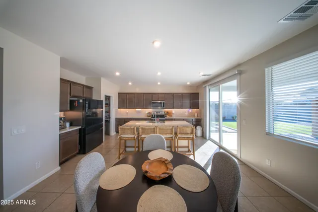 a dining room with furniture and a kitchen
