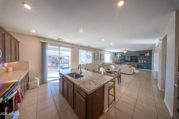 a kitchen with a counter top space a sink a stove and cabinets