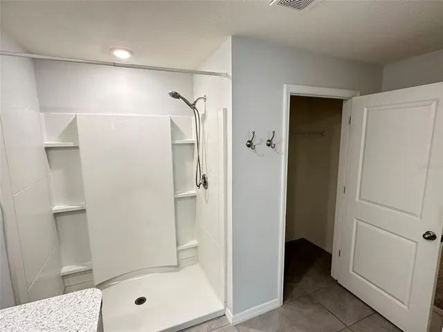 a bathroom with a shower and a sink