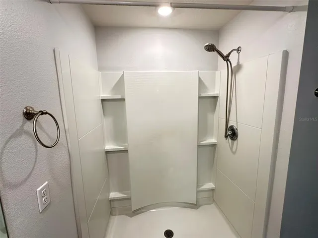 a bathroom with a shower and toilet