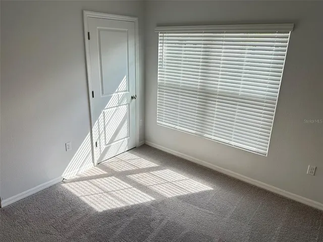 a view of a livingroom with an empty space and a window