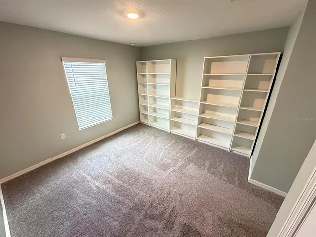 a view of room with walk in closet and window