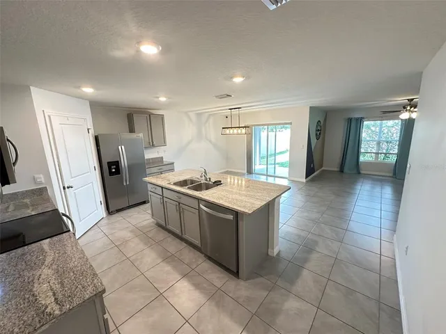 a large white kitchen with a large window