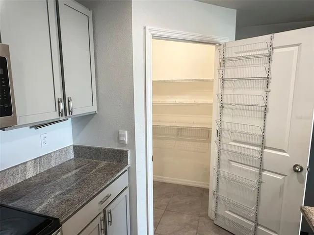 a view of walk in closet and bedroom