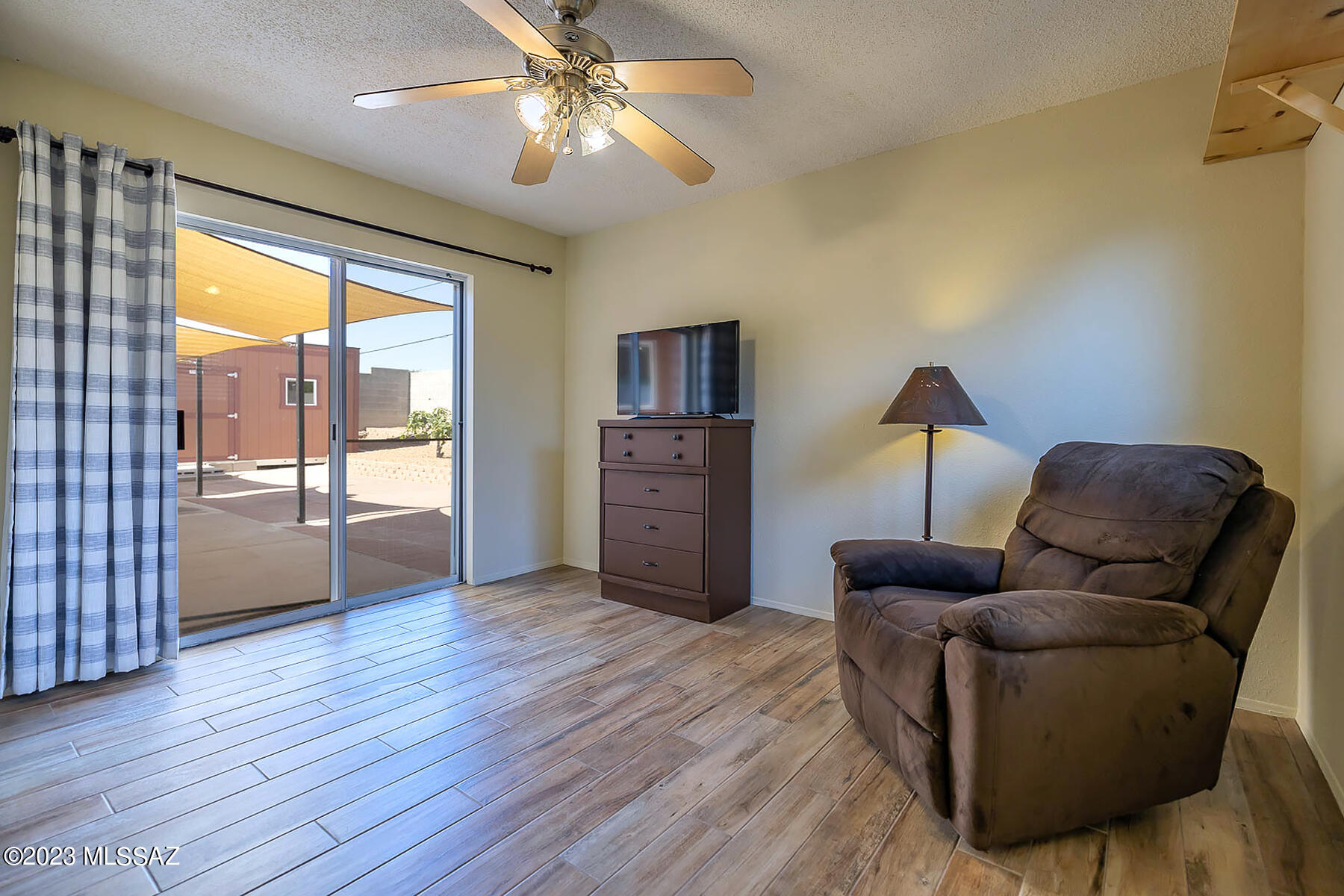 1286 South Gecko Road Tucson, AZ 85713 - Photo 22 of 27 a living room with furniture and a ceiling fan