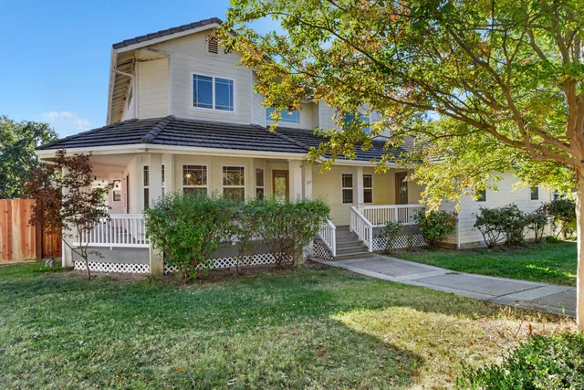 a view of a house with backyard sitting area and garden