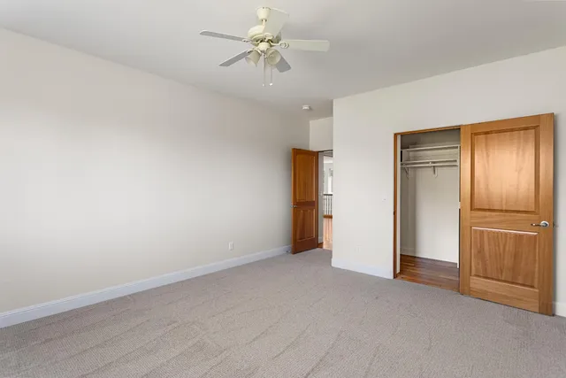 a view of an empty room with a ceiling fan