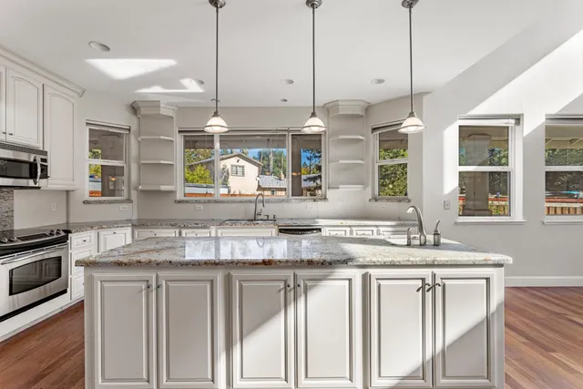 a kitchen with center island and windows
