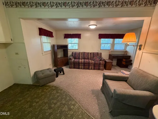 a view of a room with wooden floor and windows