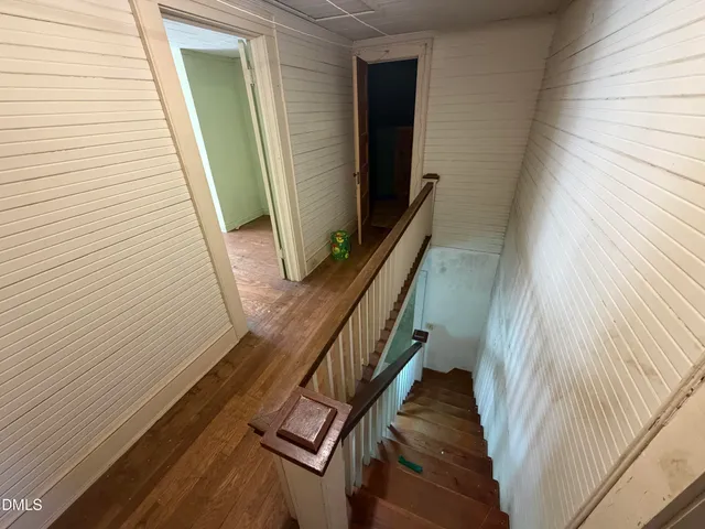 a view of stairs and wooden floor