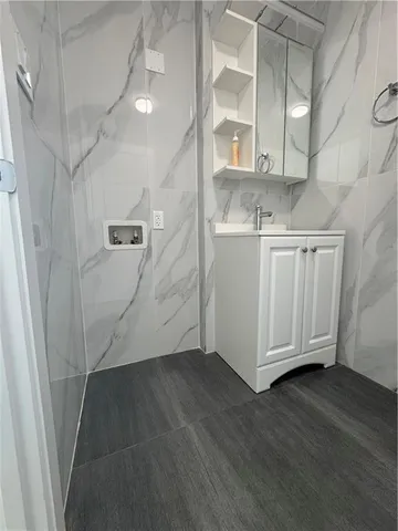 a bathroom with a toilet sink and mirror