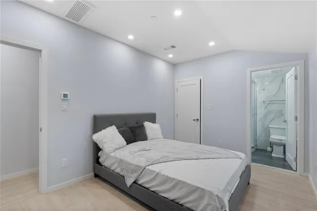 a bedroom with a bed and a night stand