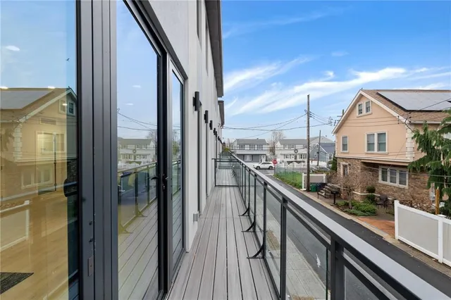 a view of a balcony with wooden floor and stairs