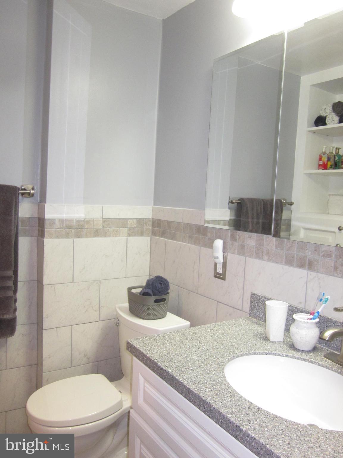 11605 Stevens Road Philadelphia, PA 19116 - Photo 22 of 44 a bathroom with a granite countertop toilet sink and mirror