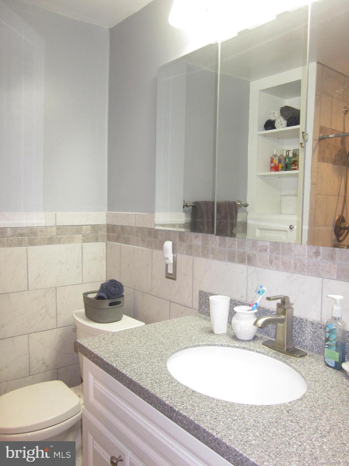 11605 Stevens Road Philadelphia, PA 19116 - Photo 24 of 44 a bathroom with a granite countertop sink a toilet a mirror and bathtub