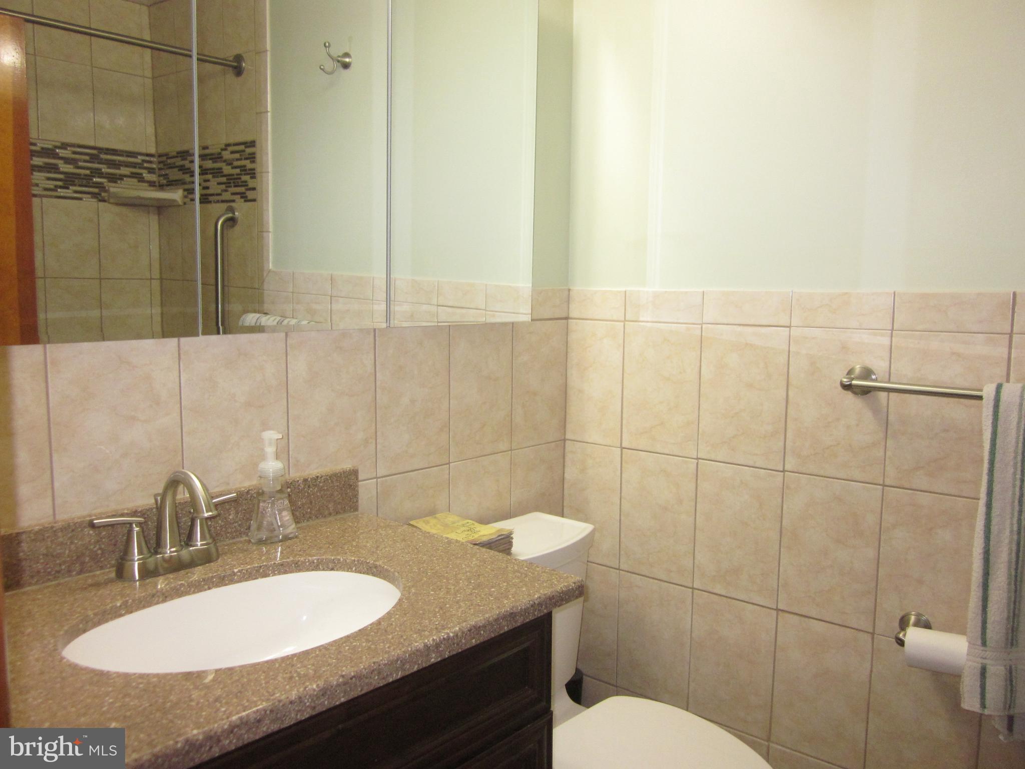 11605 Stevens Road Philadelphia, PA 19116 - Photo 28 of 44 a bathroom with a granite countertop sink toilet and shower