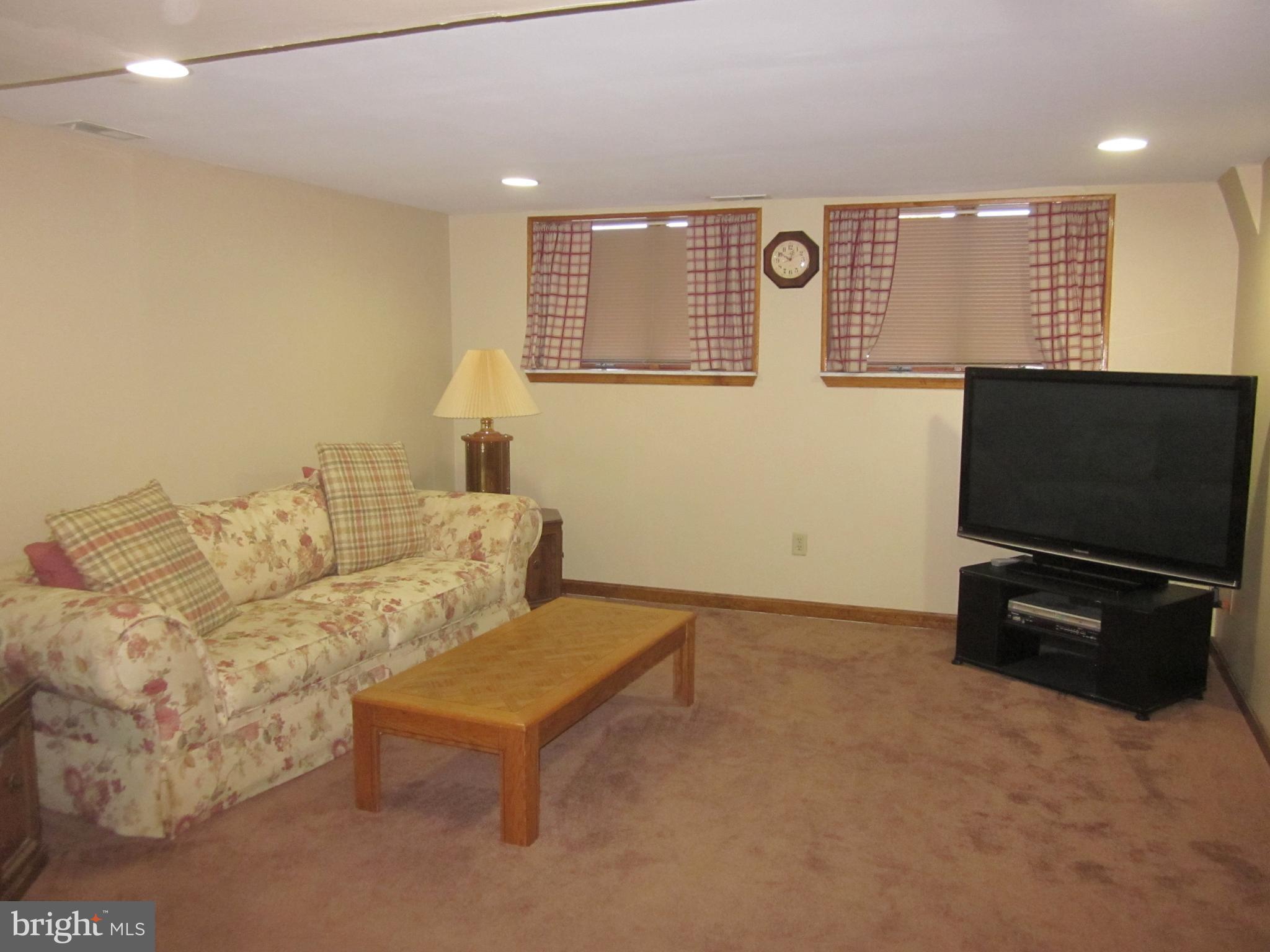 11605 Stevens Road Philadelphia, PA 19116 - Photo 33 of 44 a living room with furniture and a flat screen tv