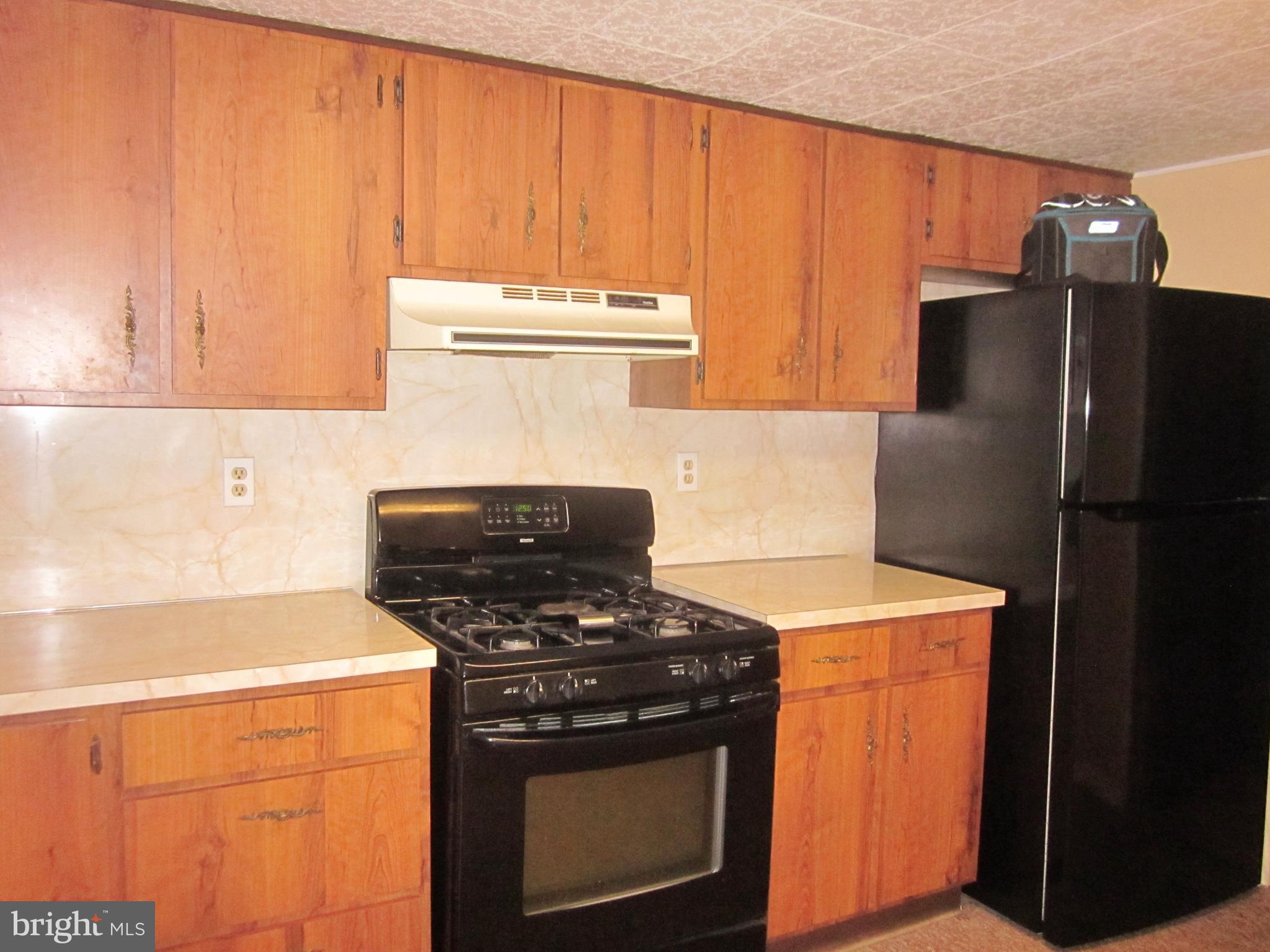 11605 Stevens Road Philadelphia, PA 19116 - Photo 36 of 44 a kitchen with a stove and a refrigerator