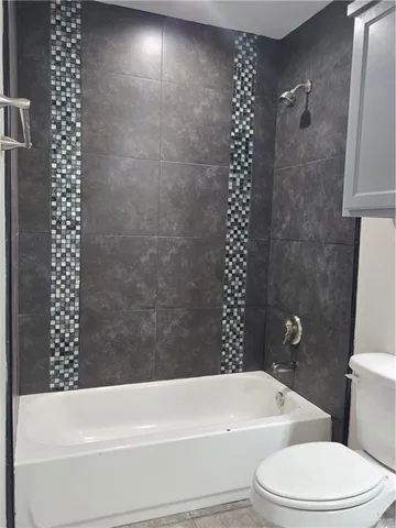 a bathroom with a toilet a sink and bathtub